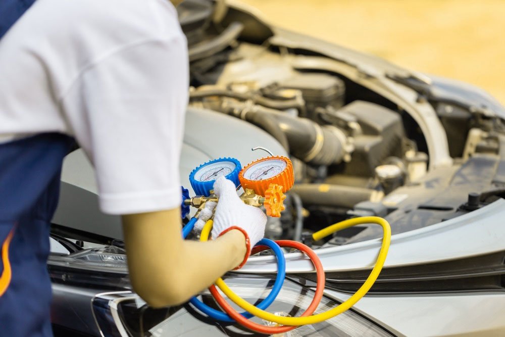 Repairman holding monitor tool to check and fixed car air conditioner system, Technician man check car air conditioning system refrigerant recharge, Air Conditioning Repair